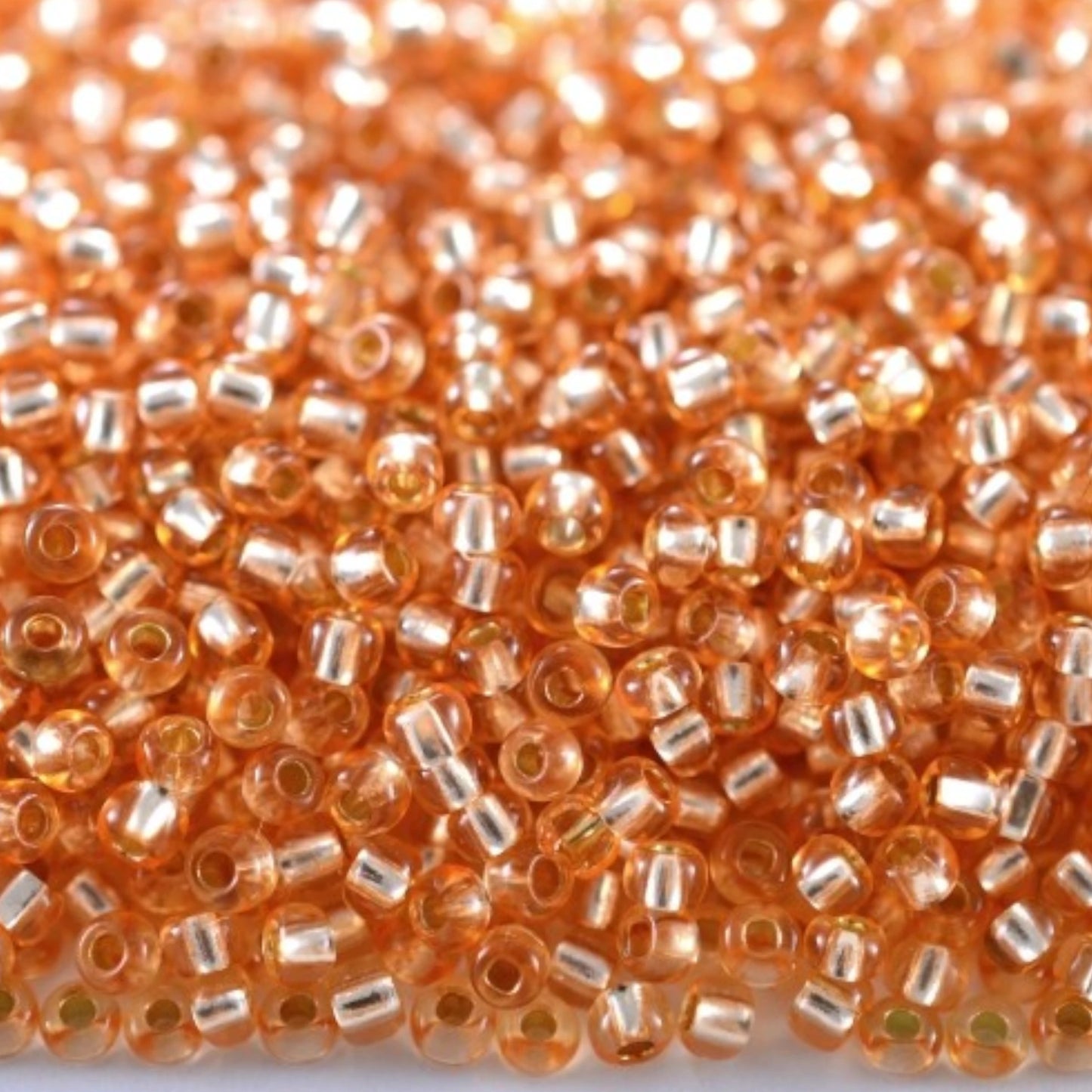 10/0 78184 Preciosa Czech Glass Seed Beads Rocailles 2.3mm. Orange 2 dyed Crystal, Silver Lined.