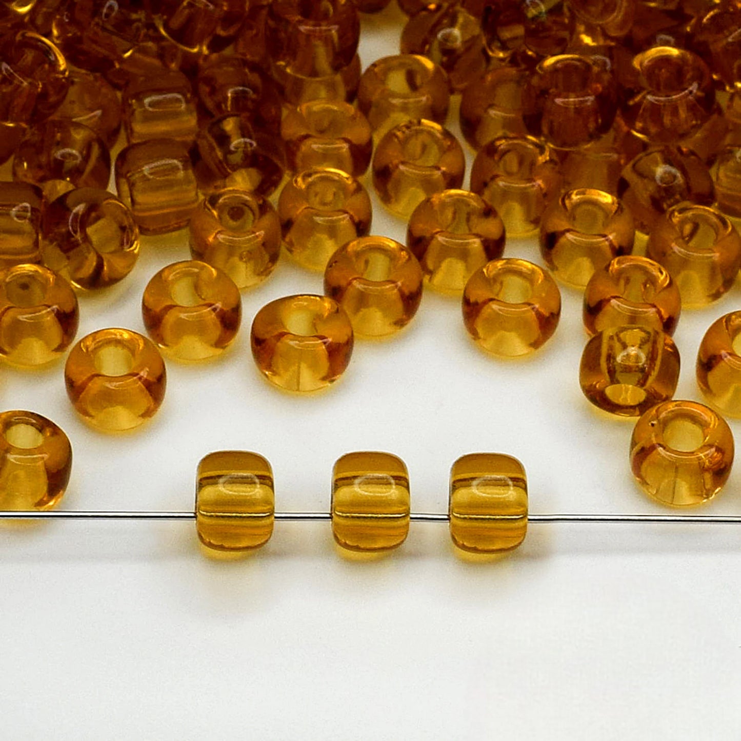 2/0 10070 Preciosa Seed Beads Yellow Brown. Transparent natural.