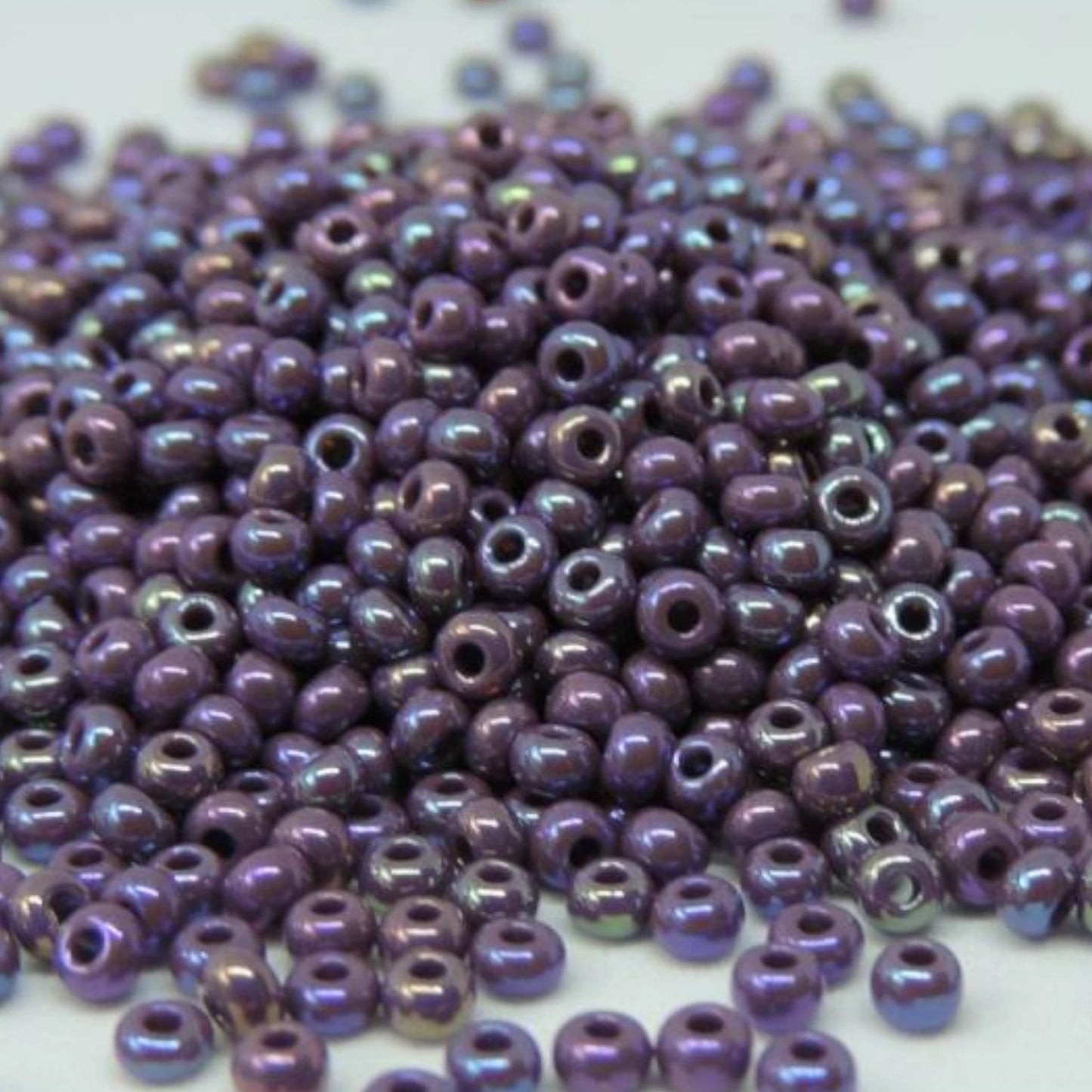 10/0 24040 Preciosa Seed Beads. Opaque rainbow purple.