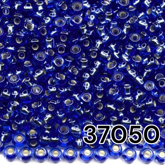 10/0 37050 Perles de graines Preciosa. Bleu transparent doublé argent.