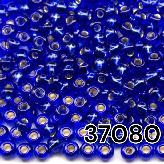 10/0 37080 Perles de graines Preciosa. Bleu transparent doublé argent.