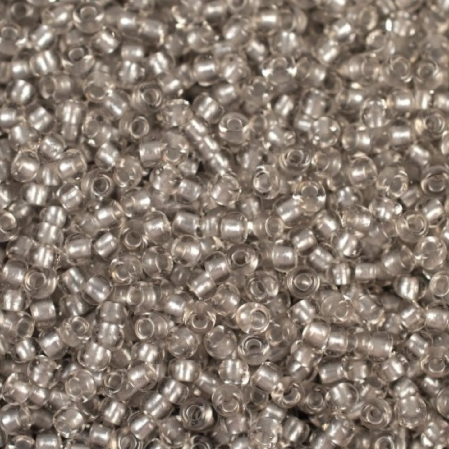 38249 Czech seed beads PRECIOSA Rocailles 10/0 grey. Crystal - Terra Pearl Lined.