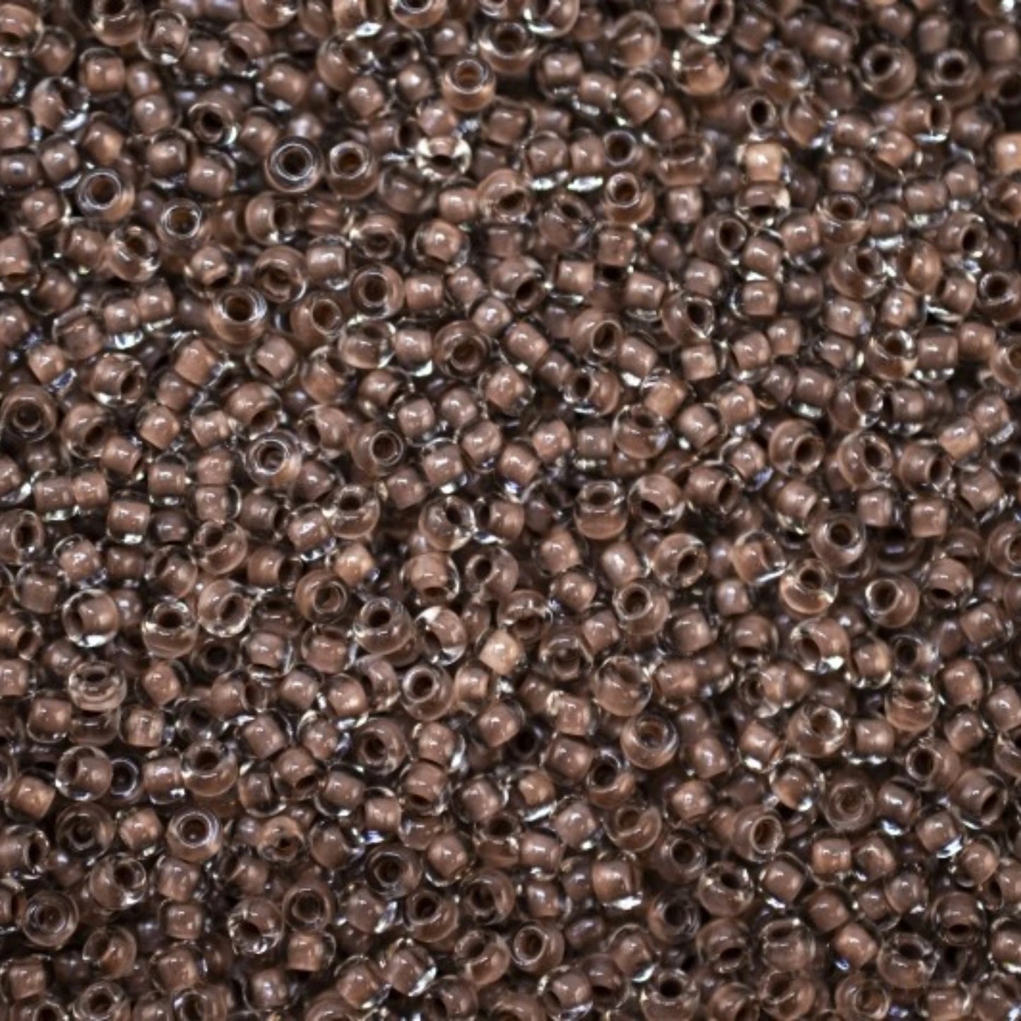 10/0 38318 Preciosa Čekiško stiklo karoliukai rokajaus 2,3 mm. Krištolo spalvos su ruda linija.