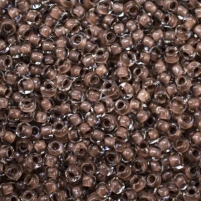 10/0 38318 Preciosa Čekiško stiklo karoliukai rokajaus 2,3 mm. Krištolo spalvos su ruda linija.