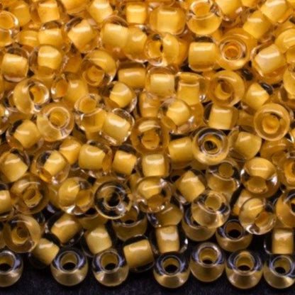 10/0 38381 Preciosa Чеський Скляний Бісер Рокайль 2.3 мм. Кришталевий Колір з Жовтим Покриттям.