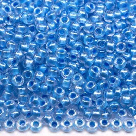 10/0 38665 Preciosa czeskie szklane koraliki Rocailles 2,3 mm. Kryształowy kolor z niebieską obwódką Sfinx.