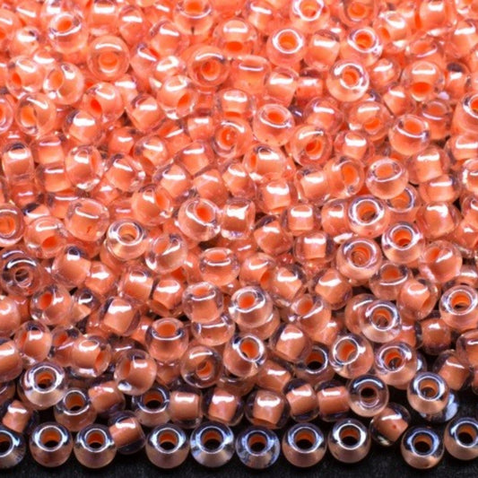 10/0 38687 Preciosa czeskie szklane koraliki Rocailles 2,3 mm. Kryształowy kolor z pomarańczową obwódką Sfinx.