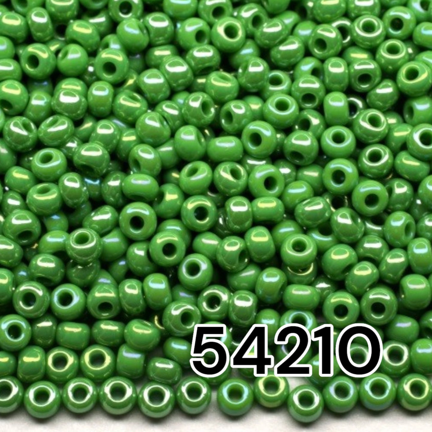 10/0 54210 Preciosa Seed Beads. Opaque rainbow green.