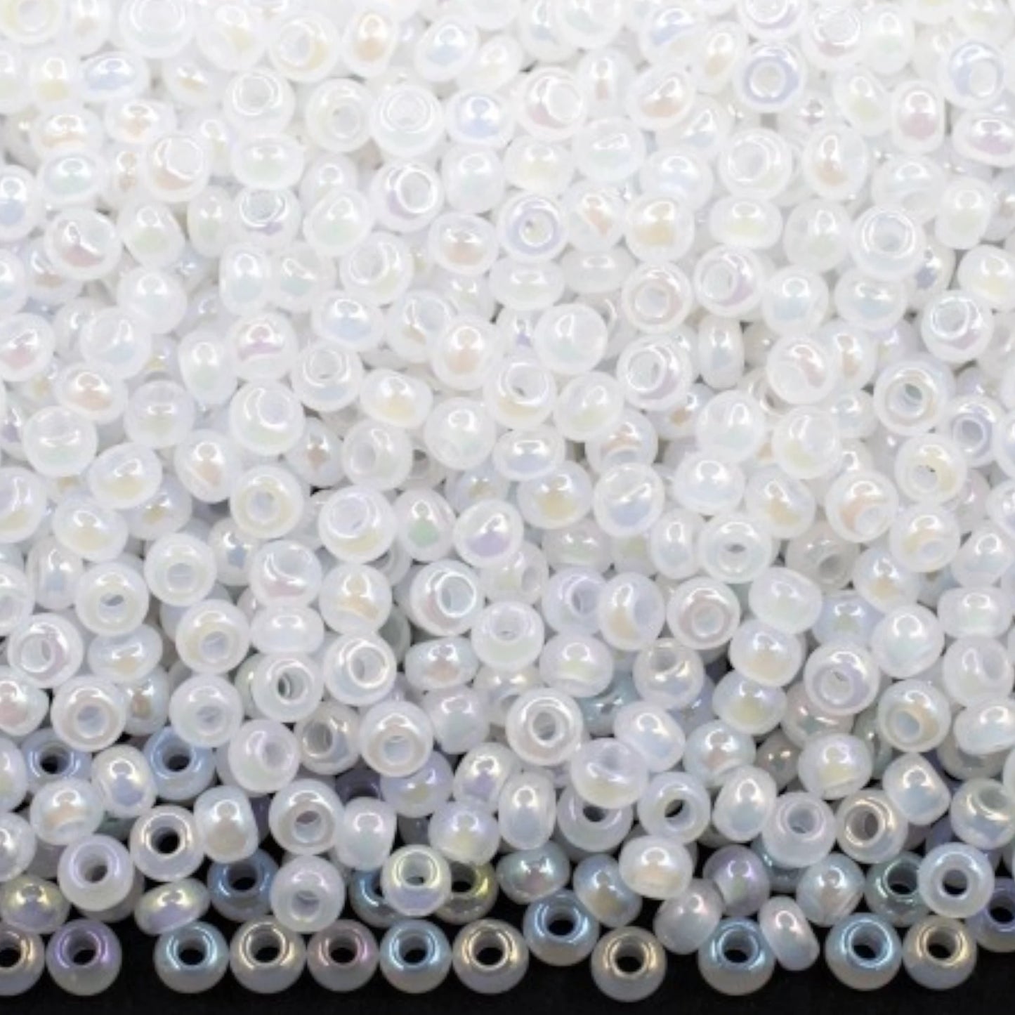 10/0 57205 Preciosa Seed Beads. Opaque rainbow white.