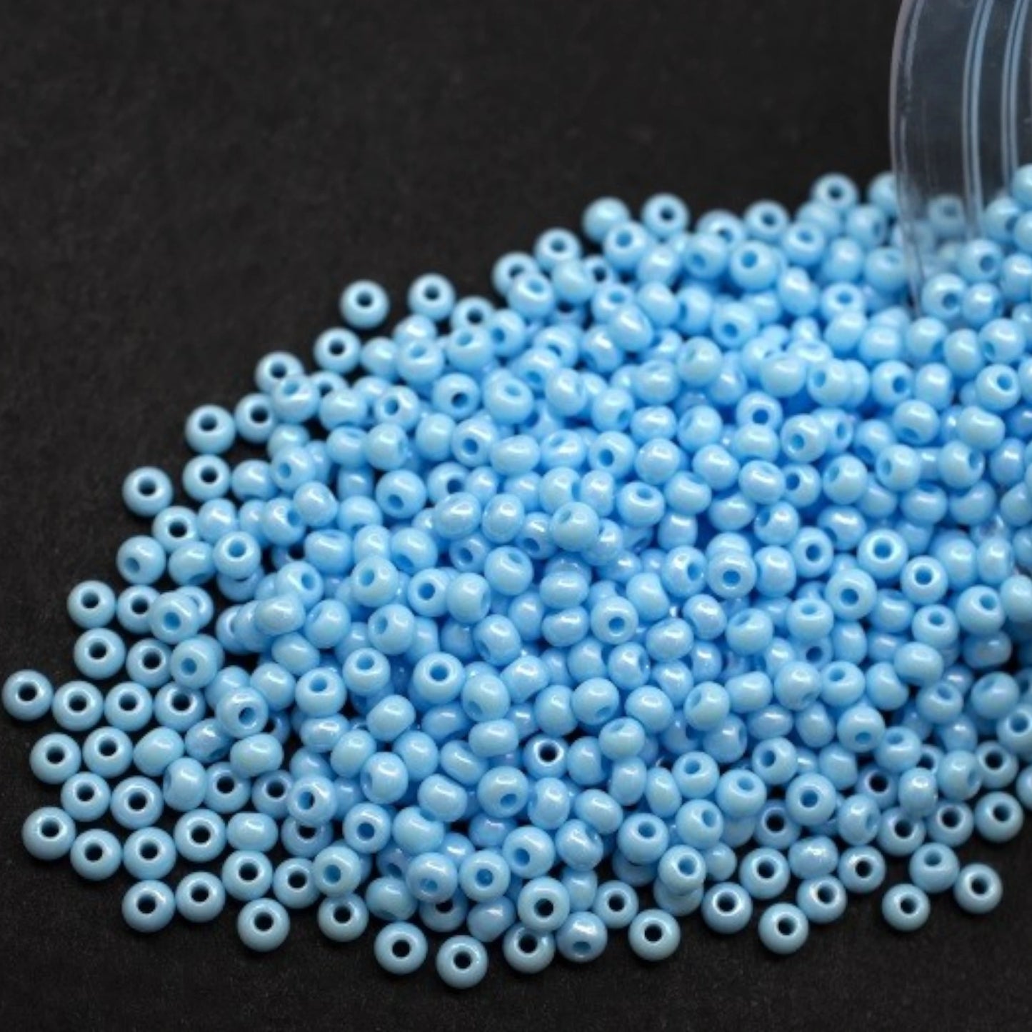 10/0 64000 Preciosa Seed Beads. Opaque rainbow light blue.