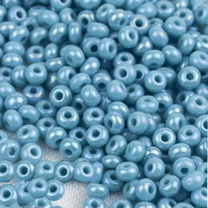 10/0 64030 Preciosa Seed Beads. Opaque rainbow light blue.