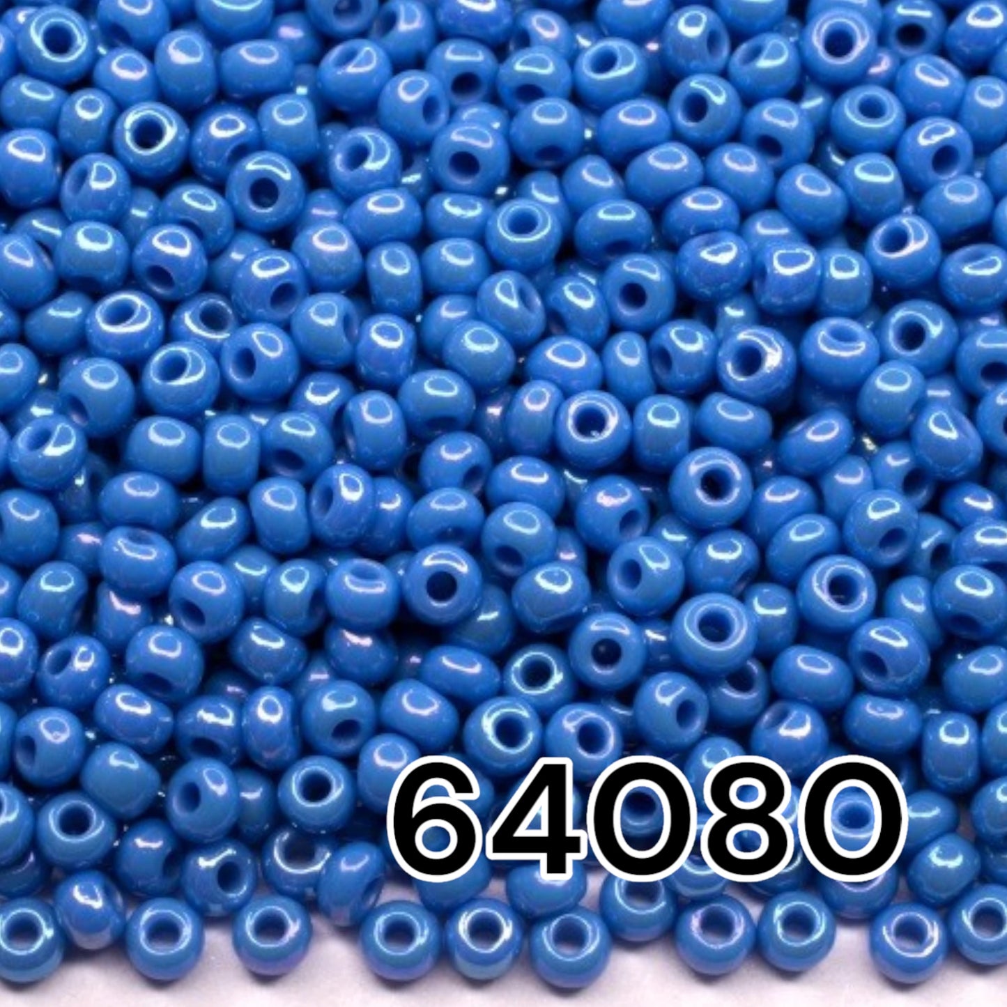 10/0 64080 Preciosa Seed Beads. Opaque rainbow blue.