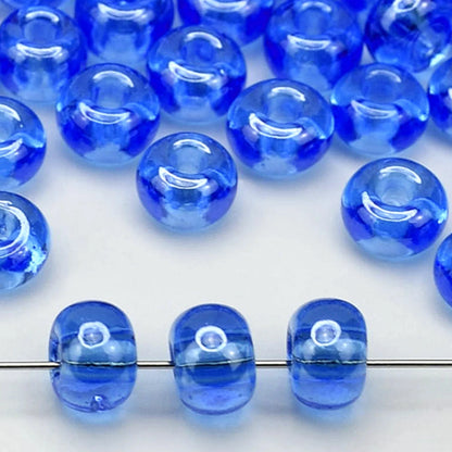 2/0 66150 Preciosa Tjeckiska glaspärlor Rocaillepärlor 6.1mm. Blå transparent Sfinx.