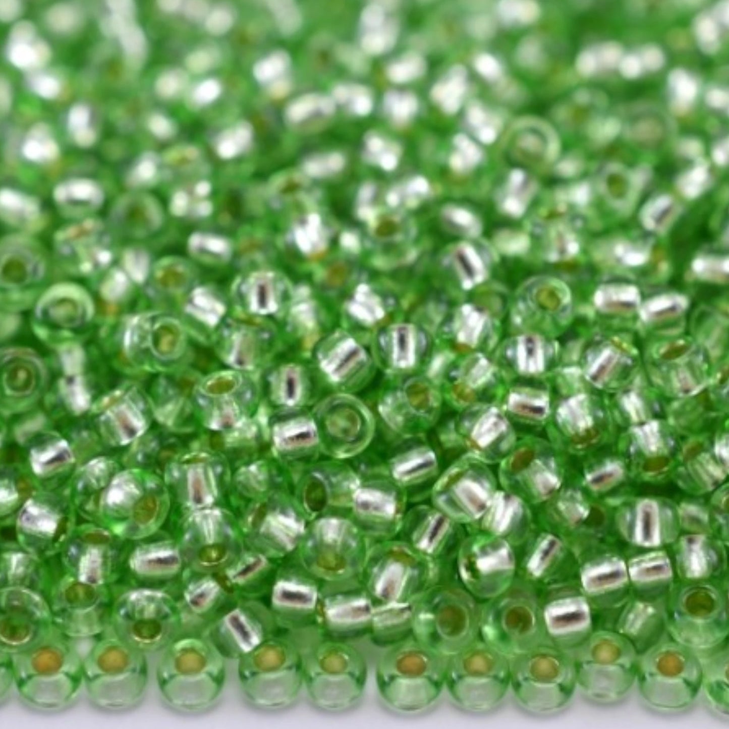 10/0 78161 Preciosa Czech Glass Seed Beads Rocailles 2.3mm. Green 2 dyed Crystal, Silver Lined.