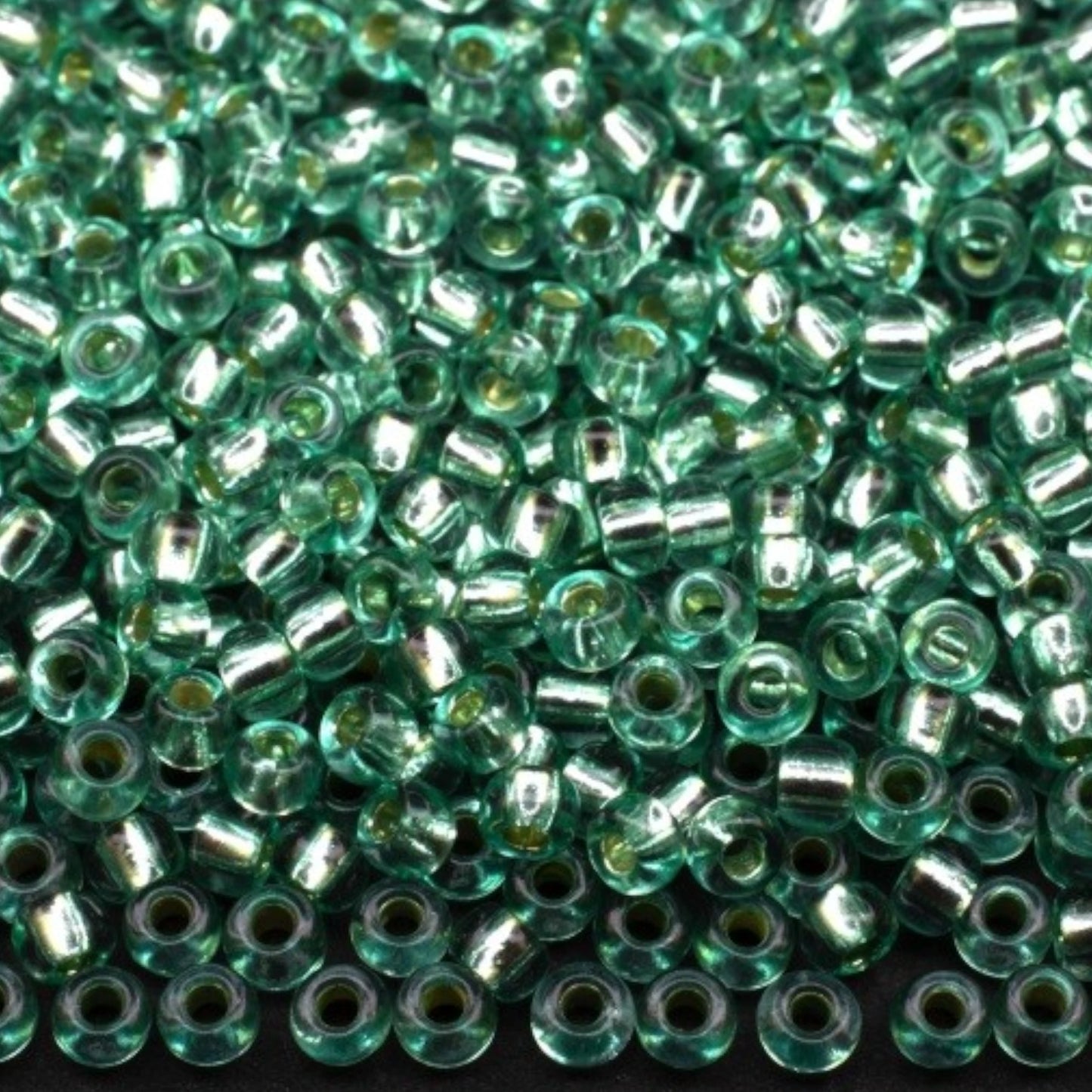10/0 78164 Preciosa Czech Glass Seed Beads Rocailles 2.3mm. Green 2 dyed Crystal, Silver Lined.