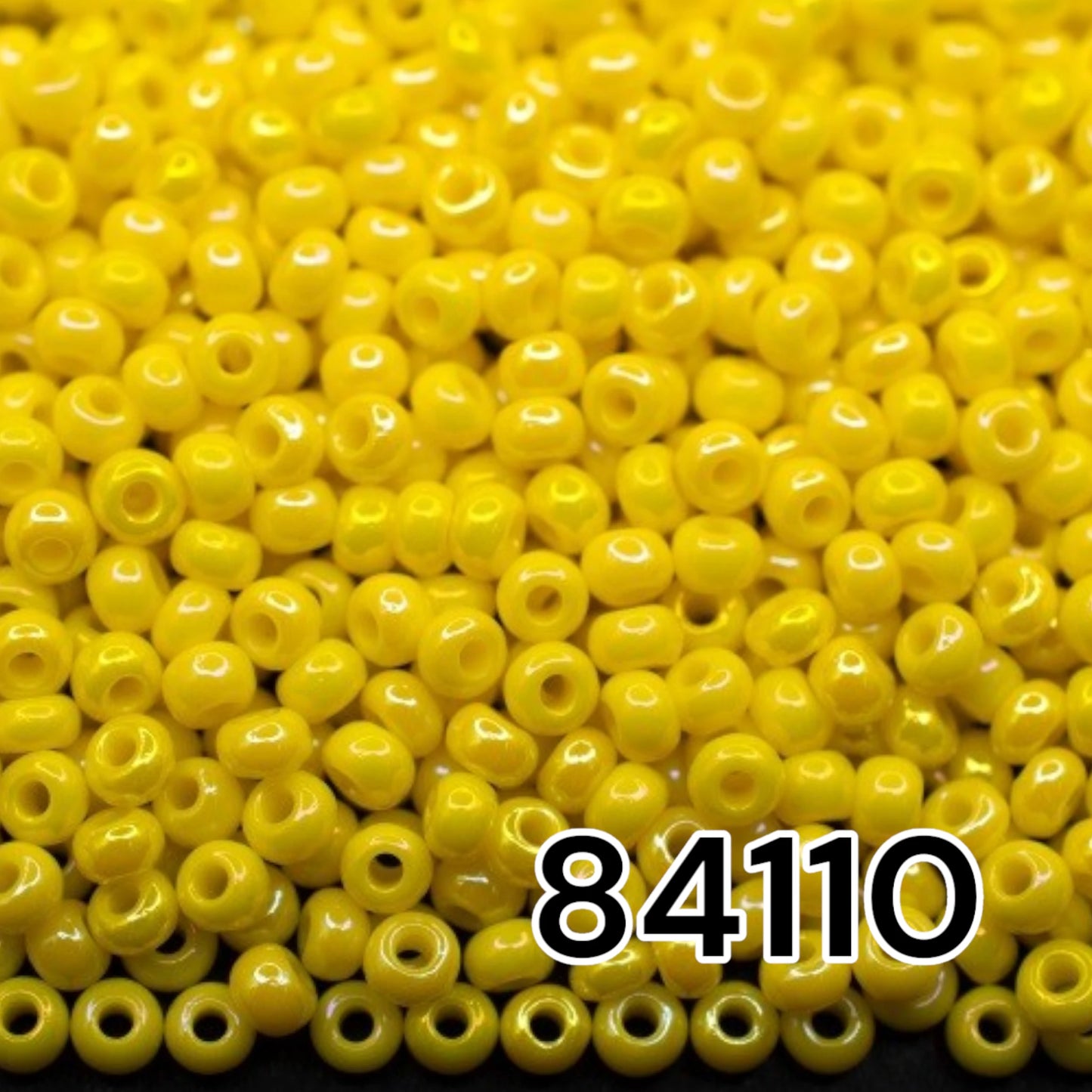 10/0 84110 Preciosa Seed Beads. Opaque rainbow yellow.