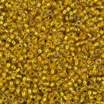 10/0 87019 Preciosa tjekkiske glasperler Perler Rocailles 2.3mm. Gennemsigtig gul ravfarvet sølvforet, regnbuefarvet.