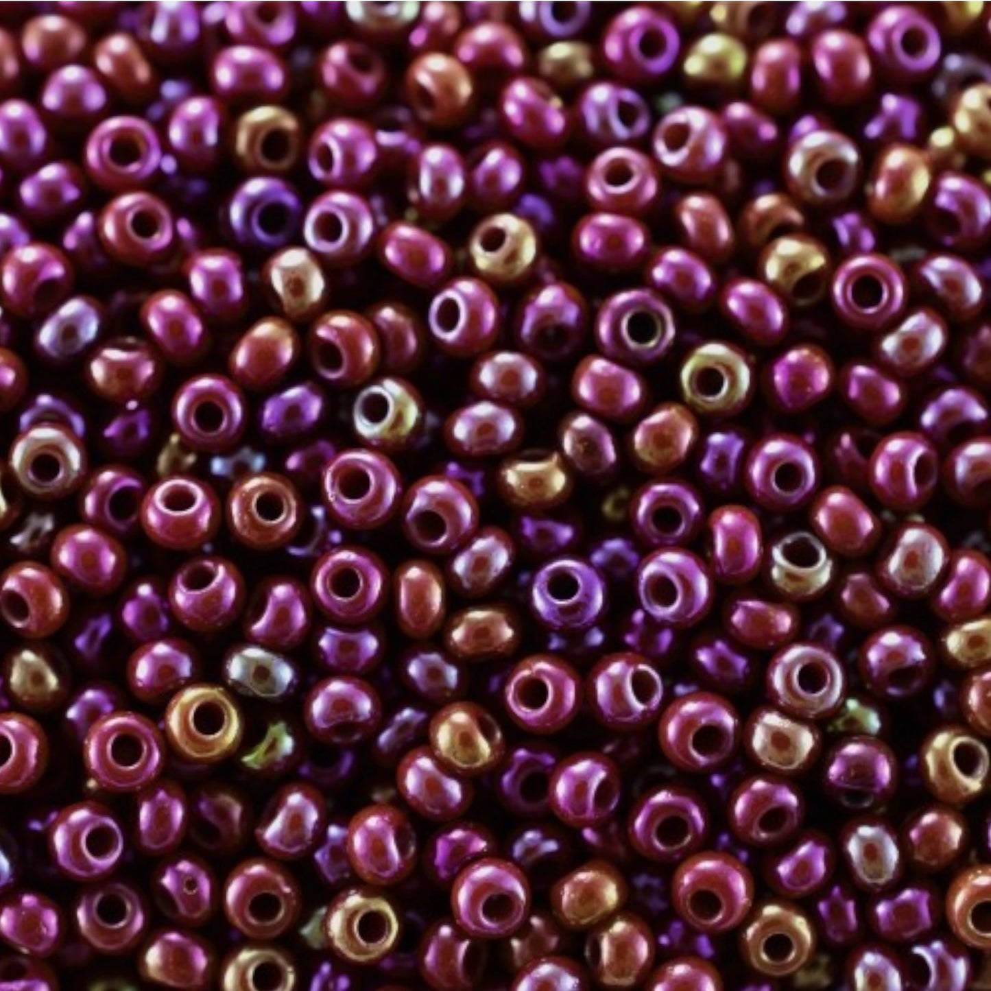 10/0 94310 Preciosa Seed Beads. Opaque rainbow burgundy .